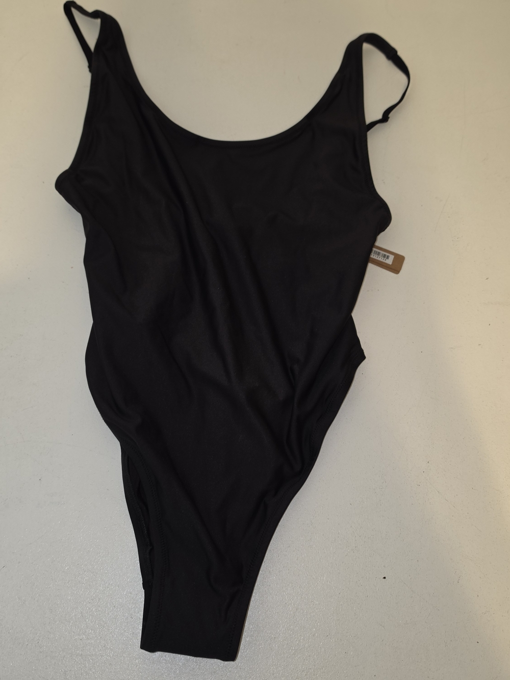 Skims Onyx scoop neck one-piece swimsuit featuring a minimalist design